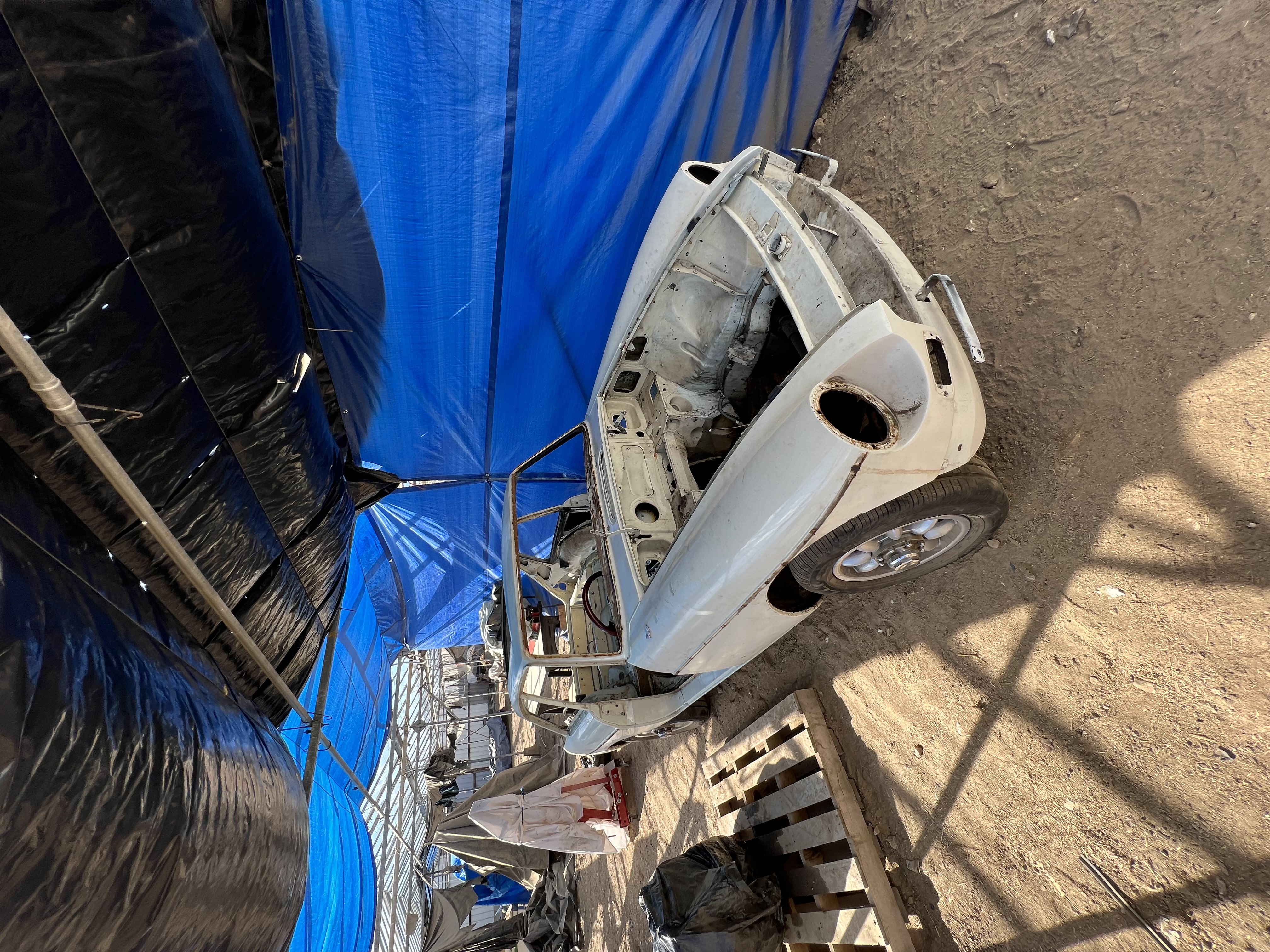 1971 MGB GT shell during restoration in a workshop with body panels removed